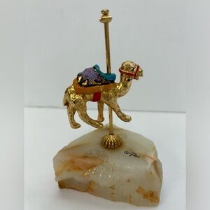 Gold figurine/ camel standing on a pole/pole is attached to onyx or quartz stone
